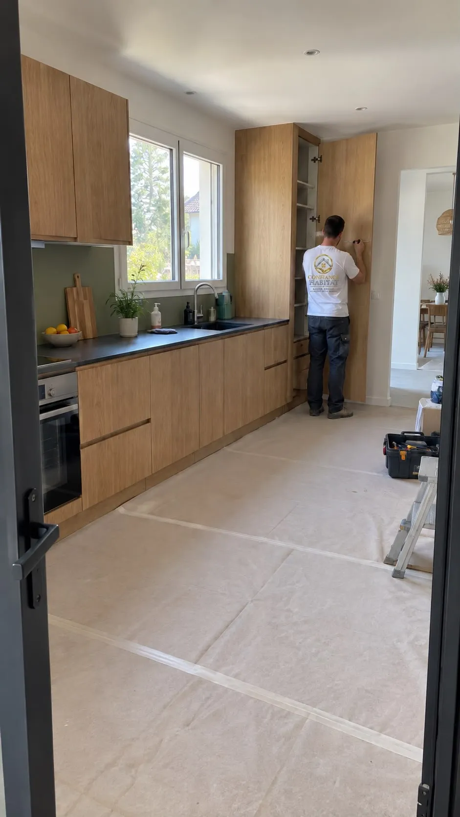 Pose d’une cuisine en bois clair avec plan de travail noir